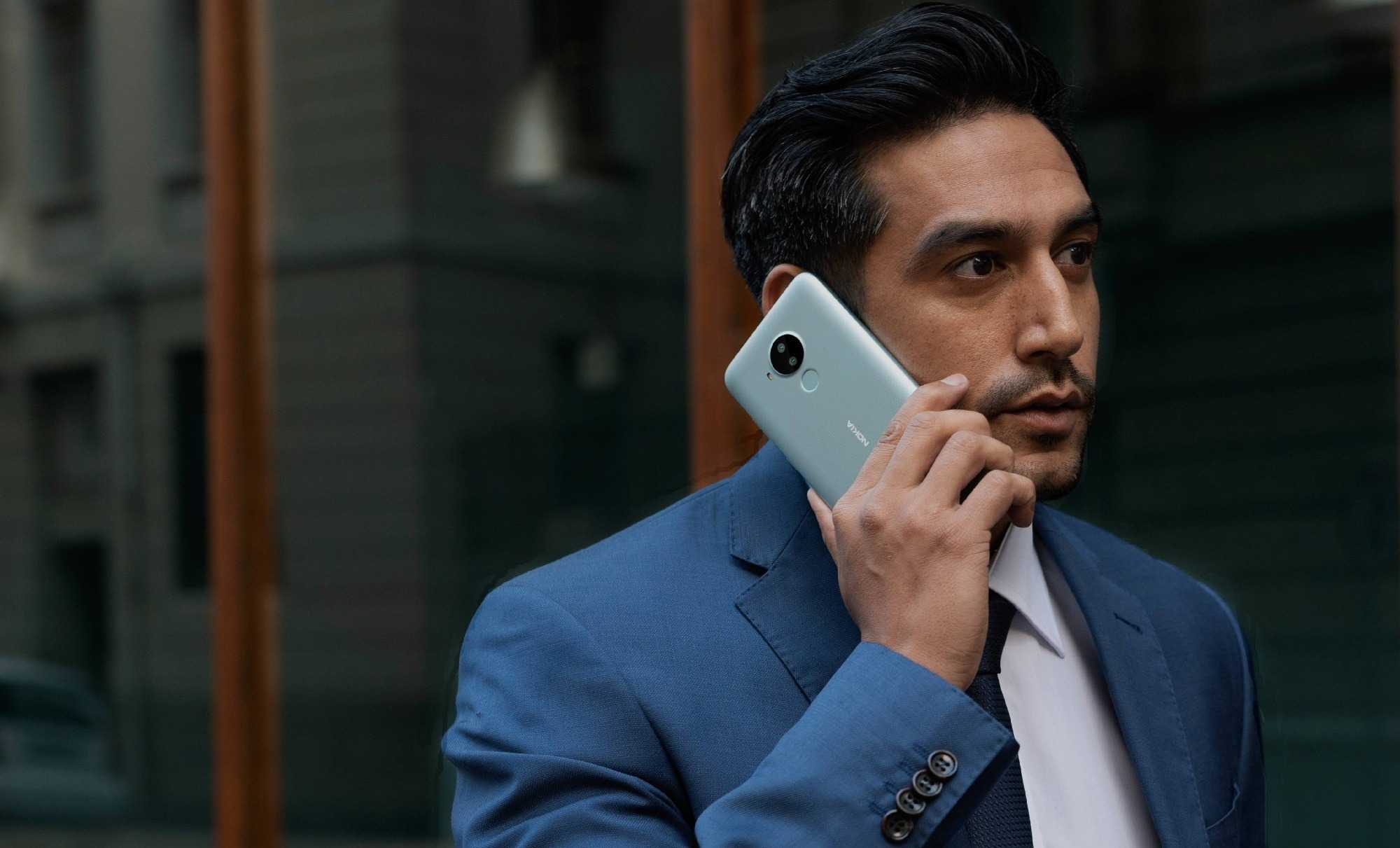 business man in blue suit talking on the phone